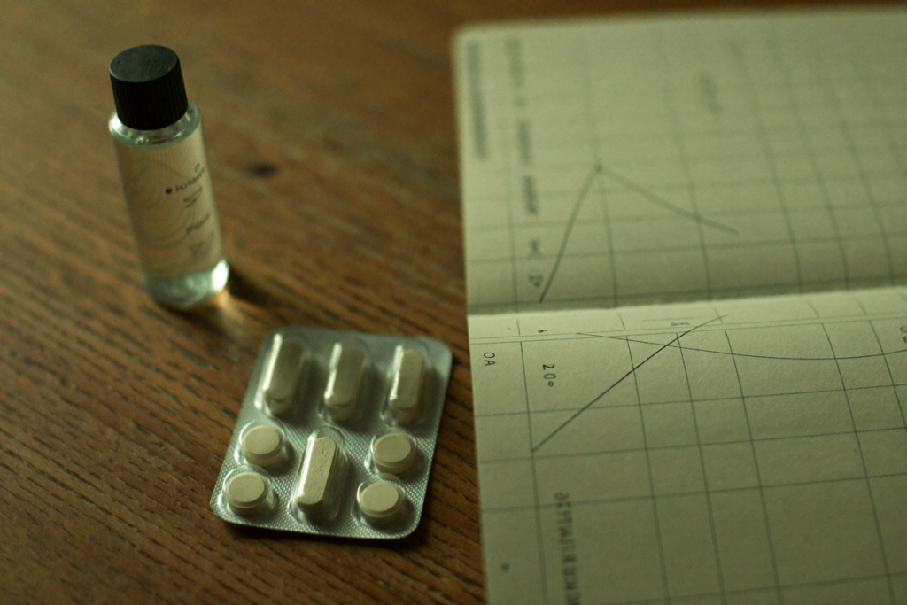 Vial and tablets beside a blank trend chart suggesting clinical trial results