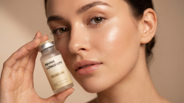 A person holding a Revive Longevity glutathione vial in a calm, sunlit wellness setting