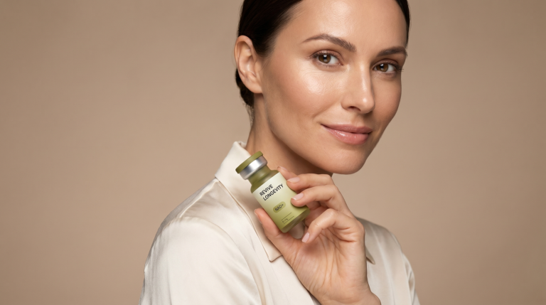 A woman holding a Revive Longevity NAD+ vial near her shoulder in a bright studio