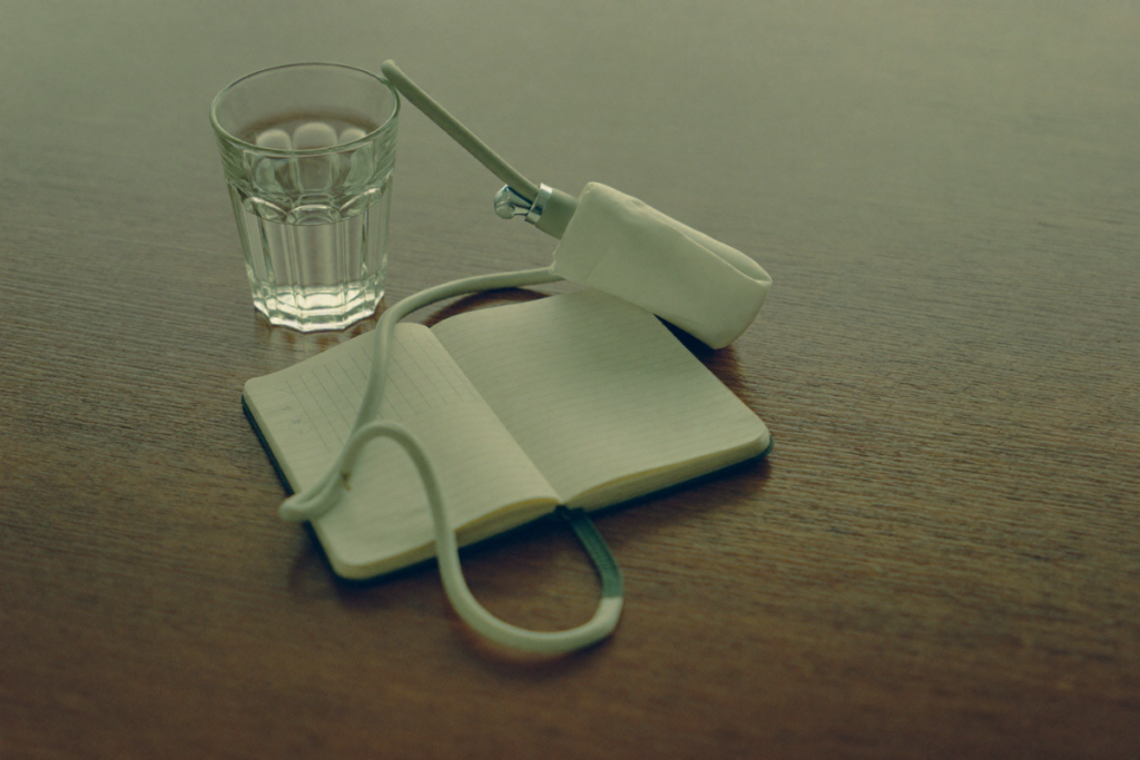 A blood pressure cuff and notebook on a wooden table, representing ongoing monitoring during testosterone therapy