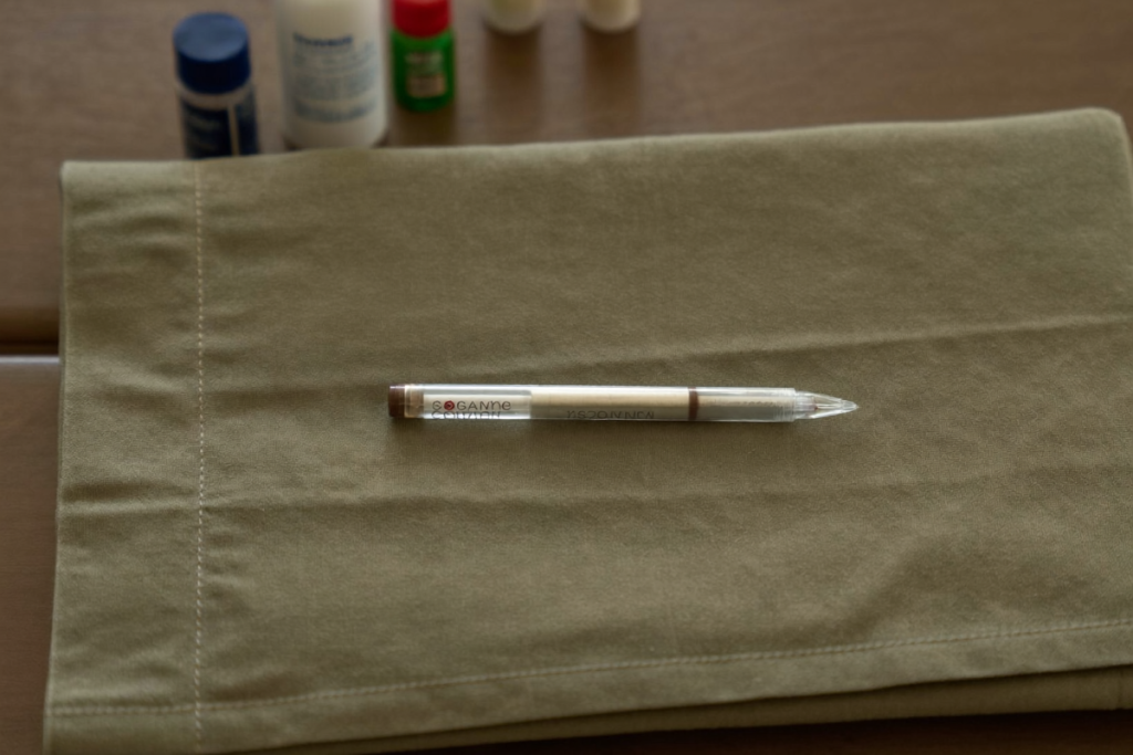 A single unbranded once-weekly injection pen on a plain cloth, representing tirzepatide in clinical study contexts